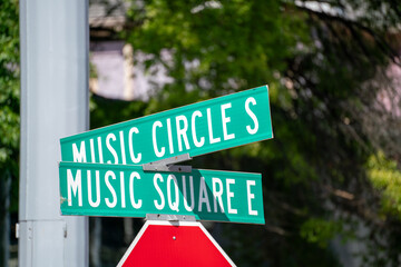 Colorful green street signs indicate the intersection of Music Circle S and Music Square E in...