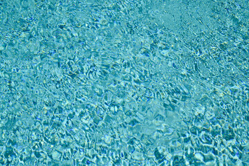 Swimming pool water with copy space. Water surface in swimming pool. Blue water background. Clear sea water texture. Sea ocean background.