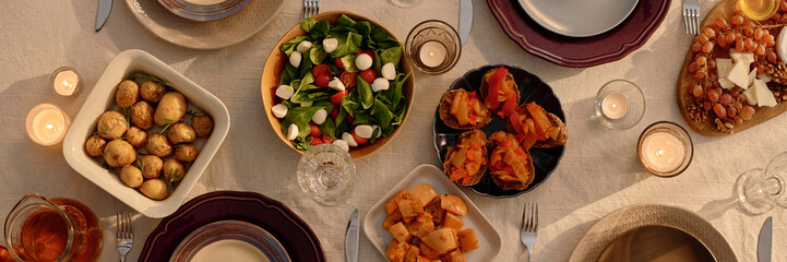 Website banner with top down shot of table covered with cotton tablecloth and served with delicious...