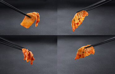 Chopsticks holding kimchi cabbage on dark background. Hot fermented napa cabbage. Collection.