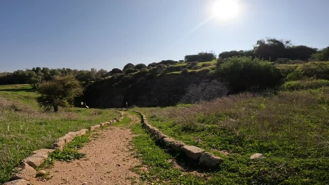 the ancient walls and ruins of Tel Ashkelon in Israel, showcasing fortifications, gates, and archaeological remains with stunning coastal views.