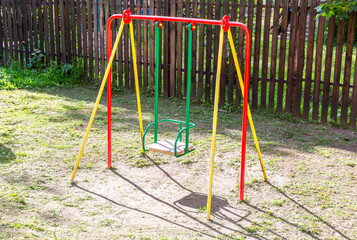 Fototapeta premium Children's metal swing for play and rest in summer