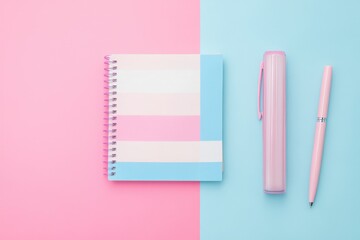 A creative flat lay of items symbolizing transgender pride: a pink, white, and blue flag, a notebook, and a pen