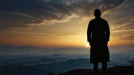 Fototapeta premium Silhouette of a devout man pray to the Allah on hill