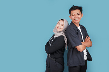 Portrait of Happy asian College man an women with jiba isolated on blue backround. Portrait of happy Asian muslim couple smiling, husband and wife hugging full of love, family concept