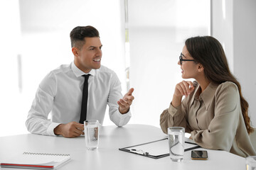 Fototapeta premium Office employees talking at table during meeting