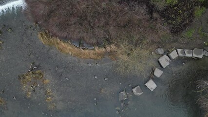 newly created natural embankment by river. benches, terraces, relaxed staircase serve people as well as fishing and relaxation. strengthening banks against water erosion by large stones on dry lined 