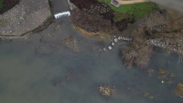 newly created natural embankment by river. benches, terraces, relaxed staircase serve people as well as fishing and relaxation. strengthening banks against water erosion by large stones on dry lined 