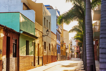 Tenerife. Colourful houses and palm trees on street in Puerto de la Cruz town, Tenerife, Canary Islands, Spain.