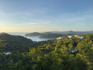 Tranquil mountain view with lush greenery and serene water during sunset