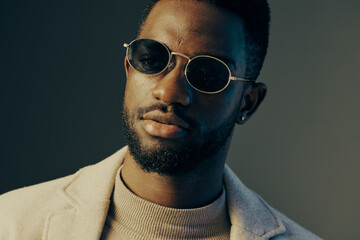 Stylish African man with sunglasses in a modern outfit, exuding confidence and sophistication...