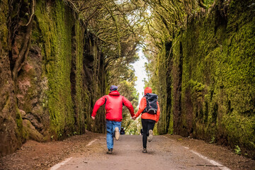 Fototapeta premium Sporty tourist couple on hiking trail in Anaga Rural Park - ancient rain forest on Tenerife, Canary Islands.