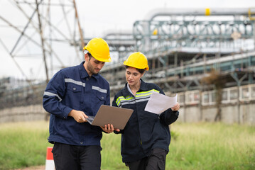 Engineer worker checking project at petrochemical factory or refinery oil plant industrial. Survey...