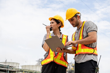 Engineer worker checking project at petrochemical factory or refinery oil plant industrial. Survey...