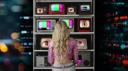 Female from behind watching a wall of Tvs with eyes