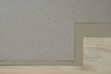 cut gray brown paper with dots on wood