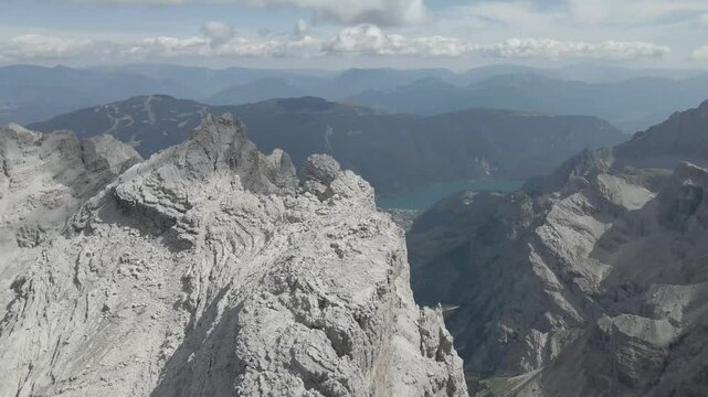 Drone footage of the Sentiero Alfredo Benini via ferrata in the Brenta Dolomites, showcasing the rugged Canalino dei Camosci and the towering Cima Grost&eacute; amid stunning alpine landscapes.