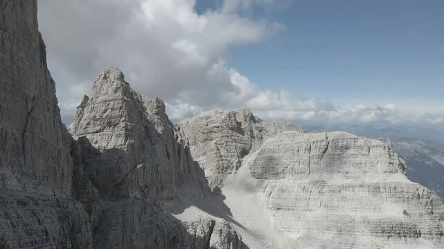 Aerial footage of the Sentiero Alfredo Benini via ferrata in the Brenta Dolomites, capturing the rugged peaks, the Canalino dei Camosci passage, and the impressive Cima Grost&eacute; with dramatic alpine sce