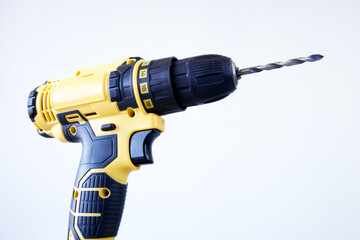 Modern cordless electric drill on gray background