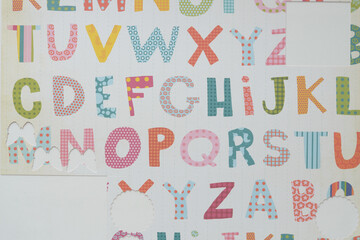 decorative scrapbooking paper with primary alphabet and cutouts