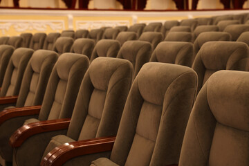 Rows of gray comfortable seats in theatre, closeup