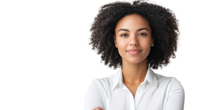 A confident young woman with curly hair smiles at the camera. She wears a white shirt, exuding positivity and professionalism in a bright setting.