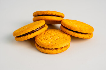 Sandwich cookies, chocolate cream filled biscuits isolated on white background, full depth of field