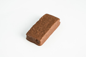 Cake bar covered with chocolate isolated on white background