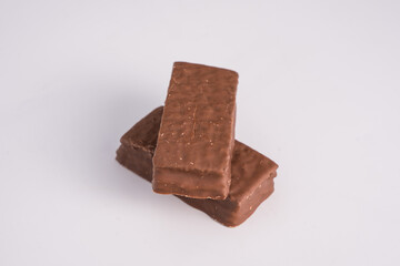 Cake bar covered with chocolate isolated on white background