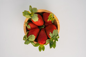 strawberry in wood plate isolated on white background