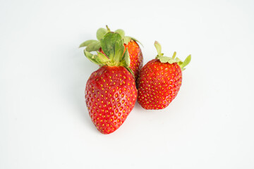 Fresh, ripe strawberry. Whole strawberry with leaf isolated on white background. Perfect retouched strawberry, not AI.