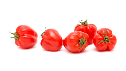 Small bright red deeply ribbed tomatoes isolated on white background
