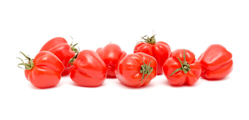 Small bright red deeply ribbed tomatoes isolated on white background
