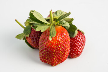 Fresh, ripe strawberry. Whole strawberry with leaf isolated on white background. Perfect retouched strawberry, not AI.