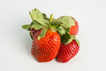 Fresh, ripe strawberry. Whole strawberry with leaf isolated on white background. Perfect retouched strawberry, not AI.