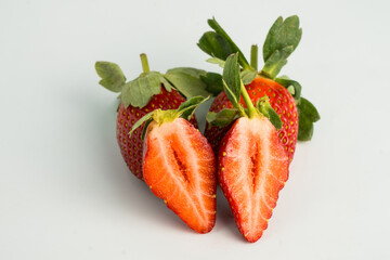 Fresh, ripe strawberry. Whole strawberry with leaf isolated on white background. Perfect retouched strawberry, not AI.