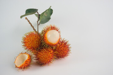 Fresh Rambutan Fruits With Leaf on a Plain White Background