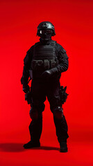 Obraz premium Elite Tactical Officer Stands Ready in Black Uniform Against Striking Red Backdrop at Night