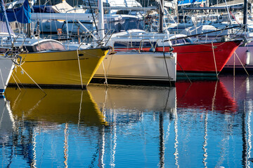 Muggia (Trieste, Italy): colored boats moored in the harbour reflecting in the water