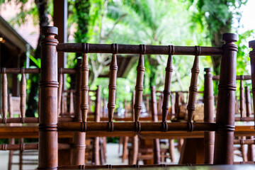 Wooden Chair Backrest Against Lush Greenery in an Outdoor Setting