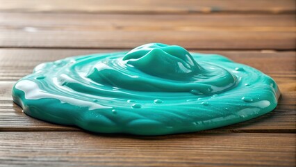 A small pool of turquoise colored slime on a table with various textures and objects nearby, creative activity, slime fun, hands off, tactile experience, messy play