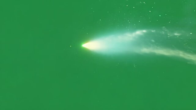 A soft glow of a comets tail dispersing into the air. Green screen chromakey.