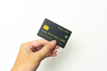 Hand of young men is holding black mockup credit cart with isolated white background