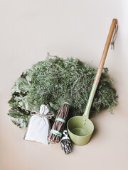 Sauna accessories: Juniper broom, dry broom for steaming, a ladle, mug, a bag of herbs. High quality photo