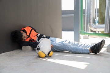Asian male worker have accident at construction site. Construction builder worker feeling sick, have a headache at work site. Health safe of work and safety first concept