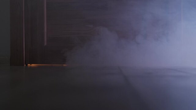 Smoke fire in the apartment. A fire starts in the house at night. Close up smoke comes out from under the door