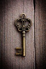 Vintage Brass Key on a Dark Textured Background