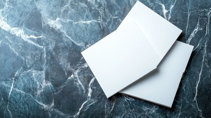 A collection of blank white sheets stacked elegantly on a dark marble surface, providing a perfect canvas for creative projects or professional presentations in minimalistic style.