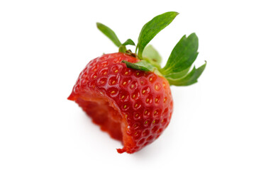 Juicy strawberry with a fresh bite taken, showcasing vibrant color and texture