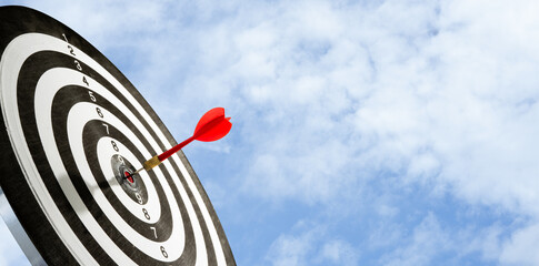 target with arrow on blue sky background for copy space